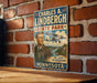 A vintage-style sign featuring a portrait of Charles A. Lindbergh, the famous aviator, and the text "Charles A. Lindbergh State Park - The Spirit of Adventure - Minnesota" against a backdrop of a scenic landscape with a small airplane.