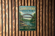 A vintage-style metal sign for Charlestown State Park, Indiana, featuring a bridge and a scenic landscape.