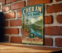A vintage-style metal sign for Cherraw State Park in South Carolina, featuring a scenic image of a lake surrounded by trees and a cabin.