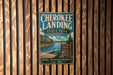 A vintage-style metal sign for Cherokee Landing State Park in Oklahoma, featuring a scenic image of the lake and surrounding landscape.