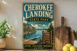 A vintage-style sign for Cherokee Landing State Park in Oklahoma, featuring a scenic image of the park and its surrounding landscape.