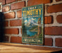 A vintage-style metal sign for Chief Timothy State Park in Washington, featuring a mountain landscape and a Native American-style figure.