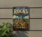A vintage-style metal sign for the City of Rocks National Reserve in Idaho, featuring a scenic mountain landscape.