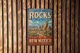 A vintage metal sign for City of Rocks State Park in New Mexico, featuring a scenic illustration of the park's landscape.
