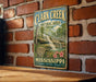 A vintage-style metal sign for Clark Creek Natural Area in Mississippi, featuring a scenic image of a waterfall surrounded by lush greenery.