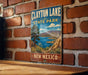 A vintage metal sign for Clayton Lake State Park in New Mexico, featuring a scenic landscape with mountains, a lake, and desert vegetation.