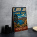 A vintage-style sign for Clayton Lake State Park in New Mexico, featuring a scenic landscape with mountains, a lake, and desert vegetation.