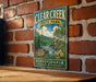 A vintage-style metal sign for Clear Creek State Park in Pennsylvania, featuring a scenic illustration of the park's natural surroundings.