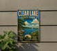 A vintage-style metal sign for Clear Lake State Park in Iowa, featuring a scenic illustration of the lake, trees, and a sailboat.