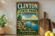 A vintage-style sign for Clinton State Park in Kansas, featuring a scenic landscape with a river, mountains, and a sailboat.