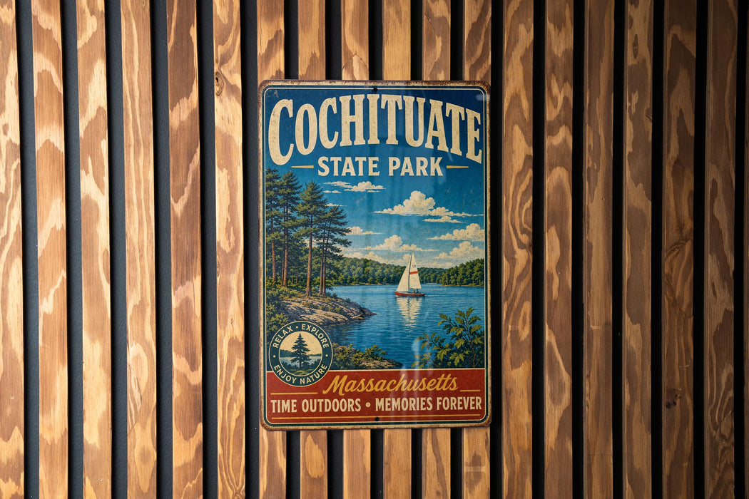 A vintage metal sign for Cochitiate State Park, featuring a scenic image of a lake with a sailboat, surrounded by trees and mountains.