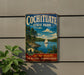 A vintage metal sign for Cochitiate State Park, featuring a scenic landscape with a sailboat on a lake surrounded by pine trees.