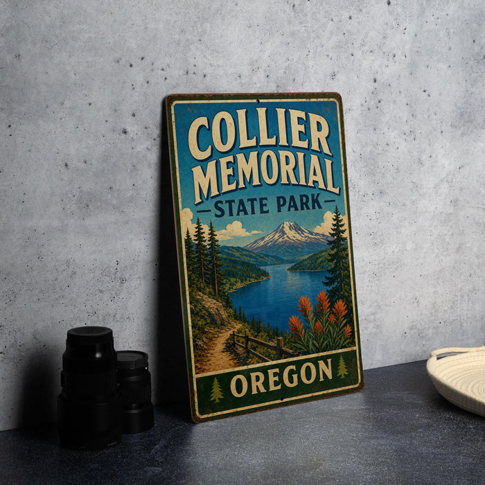 A vintage-style sign for Collier Memorial State Park in Oregon, featuring a scenic landscape with mountains, a lake, and pine trees.