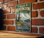 A vintage metal sign for Collis P. Huntington State Park in Connecticut, featuring a castle and a scenic landscape.