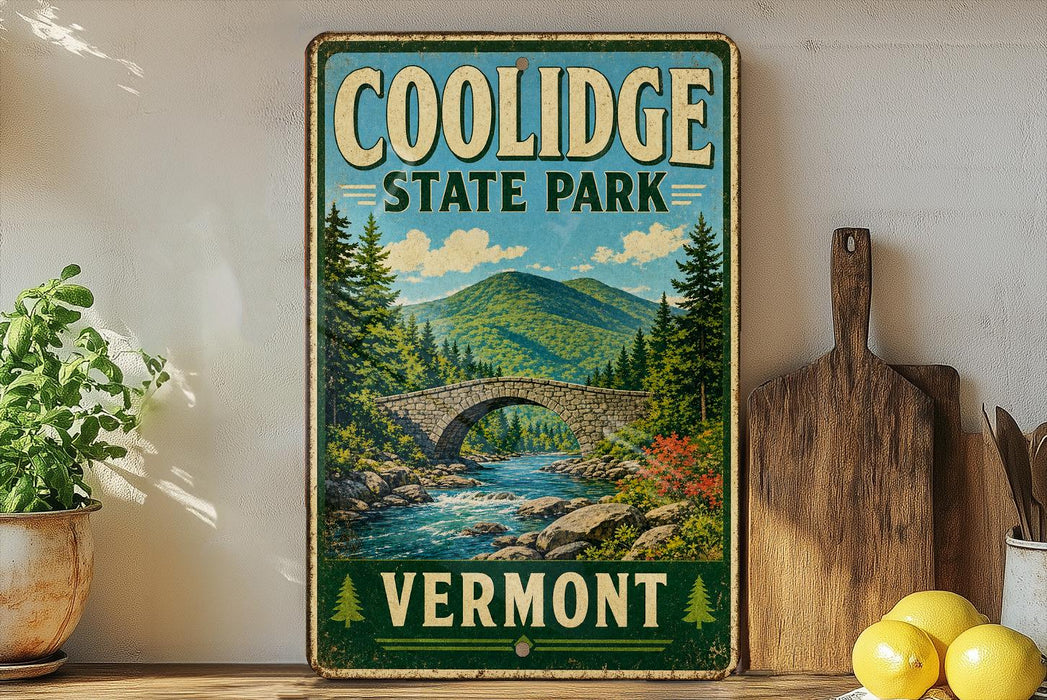 A vintage-style sign for Coolidge State Park in Vermont, featuring a scenic illustration of a stone bridge over a river surrounded by pine trees and mountains.