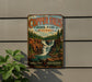 A vintage-style metal sign for Copper Falls State Park in Wisconsin, featuring a scenic illustration of a waterfall surrounded by pine trees.
