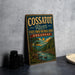 A vintage-style metal sign for the Cossat River State Park-Natural Area in Arkansas, featuring a scenic landscape with a river, mountains, and trees.