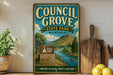 A vintage-style sign for Council Grove State Park in Montana, featuring a scenic landscape with a river and mountains.