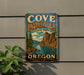 A vintage metal sign for Cove Palisades State Park in Oregon, featuring a scenic landscape with mountains, trees, and a river.