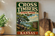 A vintage-style sign for Cross Timbers State Park in Kansas, featuring a scenic landscape with a river, trees, and mountains.