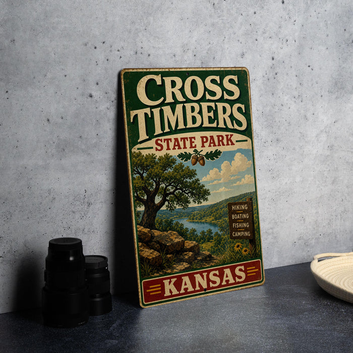 A vintage metal sign for Cross Timbers State Park in Kansas, featuring a scenic landscape with a tree, river, and mountains.