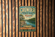 A vintage metal sign for Crowder State Park in Missouri, featuring a scenic landscape with a river and mountains.