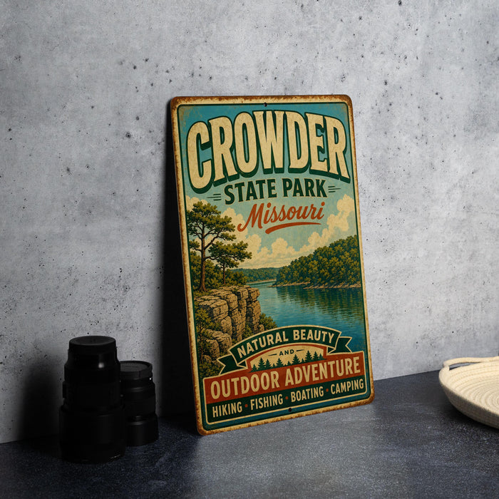 A vintage metal sign for Crowder State Park, Missouri, featuring a scenic landscape with a lake and mountains.