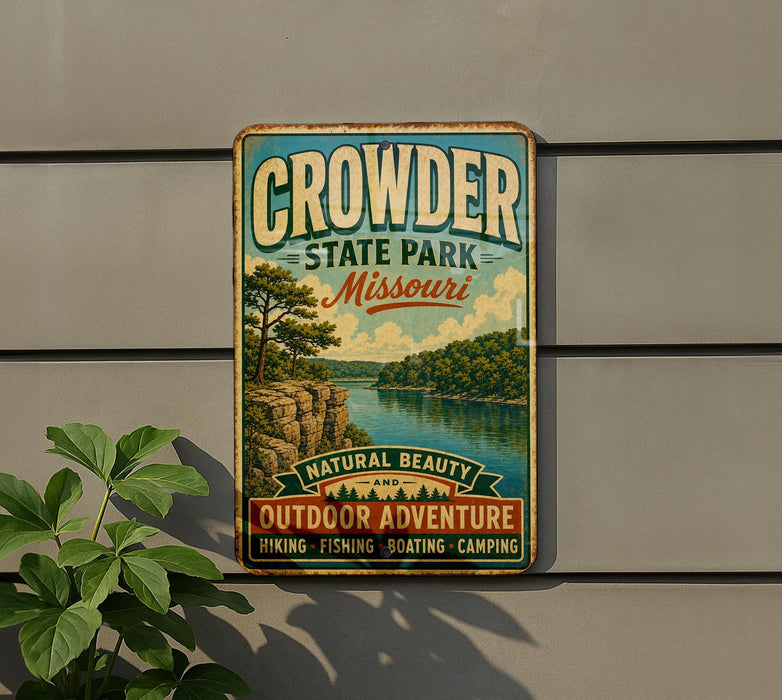 A vintage metal sign for Crowder State Park in Missouri, featuring a scenic landscape with a river and trees.