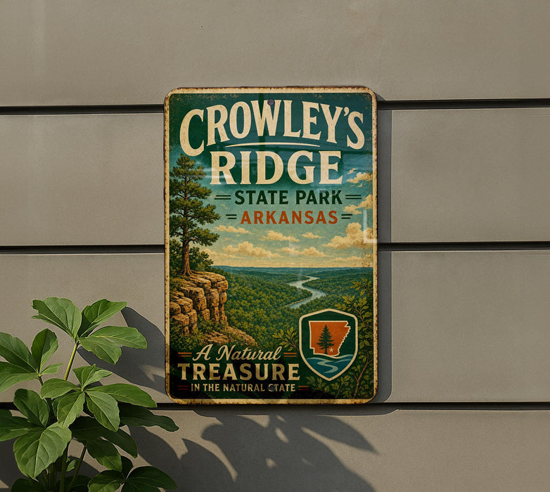 A vintage metal sign for Crowley's Ridge State Park in Arkansas, featuring a scenic landscape with a river and mountains.