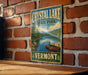 A vintage-style sign for Crystal Lake State Park in Vermont, featuring a scenic image of a lake with a canoe and mountains in the background.