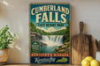 A vintage-style sign for Cumberland Falls State Resort Park in Kentucky, featuring a waterfall and lush greenery.