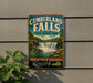 A vintage-style sign for Cumberland Falls State Resort Park in Kentucky, featuring a waterfall and lush greenery.