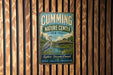 a vintage metal sign for the Cumming Nature Center in New York, with a bird illustration and text promoting exploration, discovery, and connection to nature.