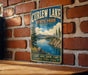 A vintage-style metal sign for Curlew Lake State Park in Washington, featuring a scenic landscape with mountains, trees, and a lake.