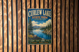 A vintage metal sign for Curlew Lake State Park in Washington, featuring a scenic landscape with a lake, mountains, and pine trees.