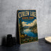 A vintage-style metal sign for Curlew Lake State Park in Washington, featuring a scenic landscape with a lake, mountains, and pine trees.