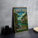 A vintage-style sign for Current River State Park in Missouri, featuring a scenic illustration of a river surrounded by lush greenery and rocky cliffs.