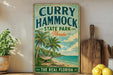 A vintage-style sign for "Curry Hammock State Park, Florida" featuring a beach scene with palm trees and a hammock.