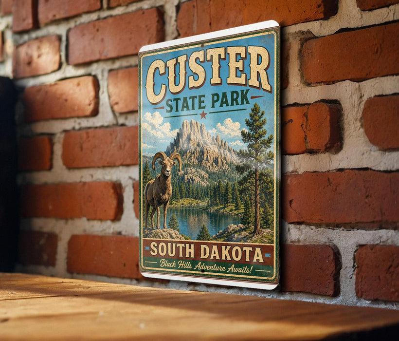 A vintage-style metal sign for Custer State Park in South Dakota, featuring a mountain landscape and a bighorn sheep.