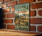 A vintage-style metal sign for Cuiyama Ranch State Park in California, featuring a scenic illustration of the park and its surroundings.