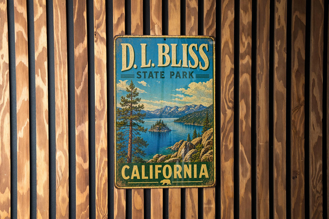 A vintage metal sign for D.L. Bliss State Park in California, featuring a scenic landscape with mountains, a lake, and a pine tree.