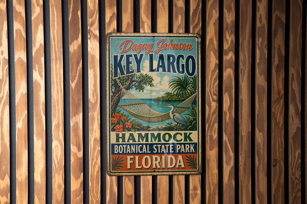 A vintage metal sign for Key Largo, a hammock botanical park in Florida, is displayed on a wooden wall.