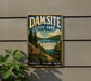 A vintage-style metal sign for Damsite State Park in New York, featuring a scenic landscape with a waterfall and a path leading to the park entrance.