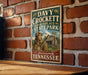 A vintage-style metal sign for Davy Crockett Birthplace State Park in Laurenceburg, Tennessee.