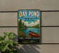 A vintage-style metal sign for Day Pond State Park in Connecticut, featuring a scenic image of a lake with a canoe, surrounded by trees and mountains.