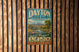 A vintage metal sign for Dayton State Park, Nevada, featuring a scenic landscape with mountains, a river, and various outdoor activities such as fishing, hiking, and picnicking.