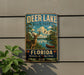 A vintage-style metal sign for Deer Lake State Park in Florida, featuring a deer in a natural setting with a lake and palm trees.
