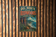 A vintage metal sign for Del Norte Coast Redwoods State Park in California, featuring a scenic illustration of the park's landscape.