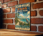A vintage-style metal sign for Delnor-Wiggs Pass State Park in Florida, featuring a beach scene with a crane and palm trees.