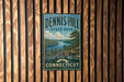 A vintage-style metal sign for Dennis Hill State Park in Connecticut, featuring a scenic landscape with a lake and mountains.